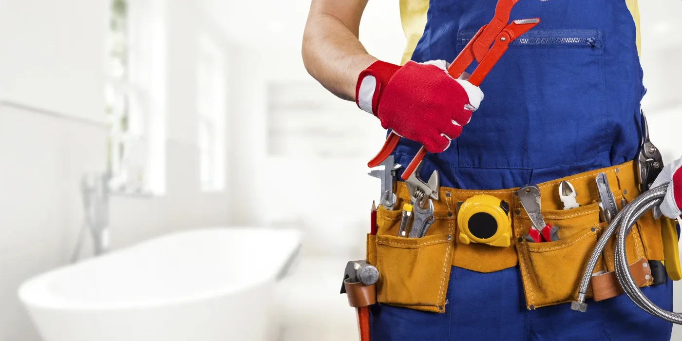 The torso of plumbing technician showing a tool belt from TMK Plumber Austin in Austin, TX - Hidrojet services The torso of plumbing technician showing a tool belt from TMK Plumber Austin in Austin, TX - Hidrojet services