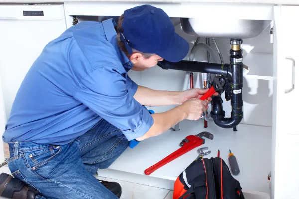 a male plumber fixing a toilet from TMK Plumber Austin in Austin, TX Plumber near me a male plumber fixing a toilet from TMK Plumber Austin in Austin, TX Plumber near me