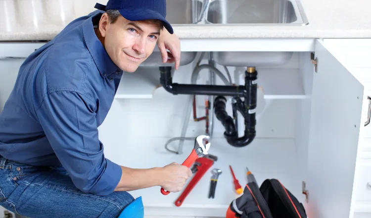 a plumber technician with a tool belt from TMK Plumber Austin in Austin, TX - Sewer backup solutions